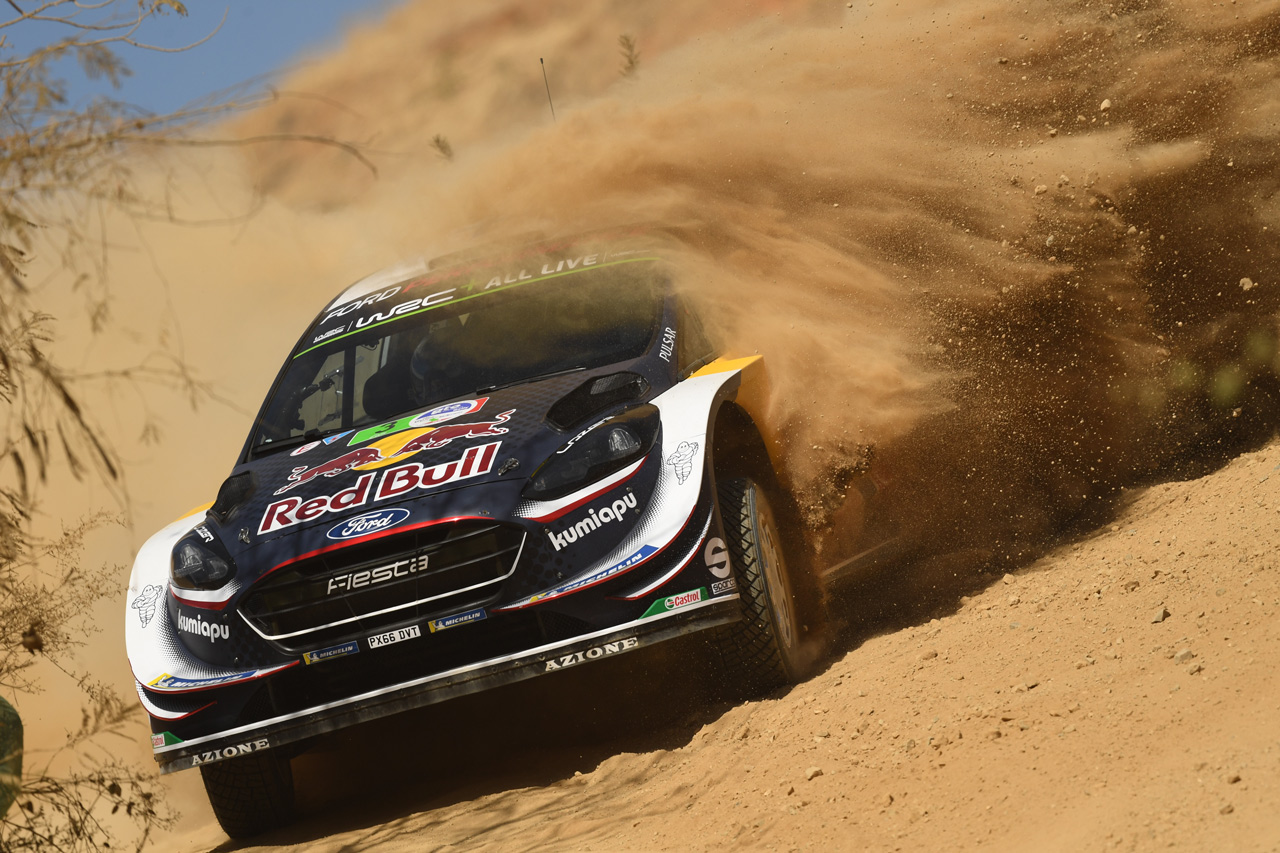 Ford rally car kicking up dust as it races across gravel and sand, photographed with the Nikon 500mm f5.6E PF ED VR Lens