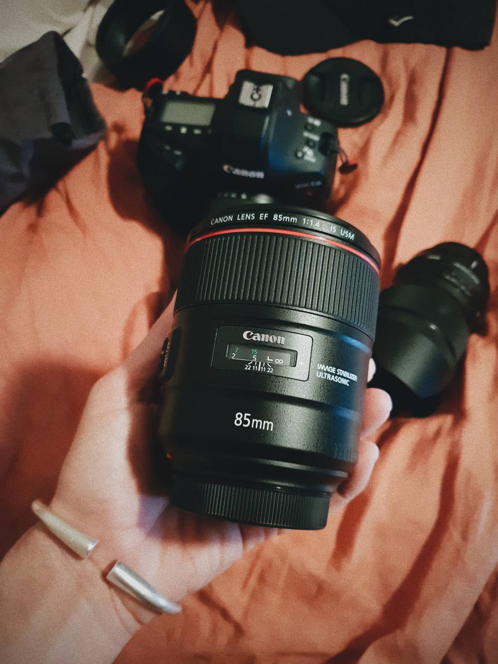 Canon 85mm lens on a man's palm