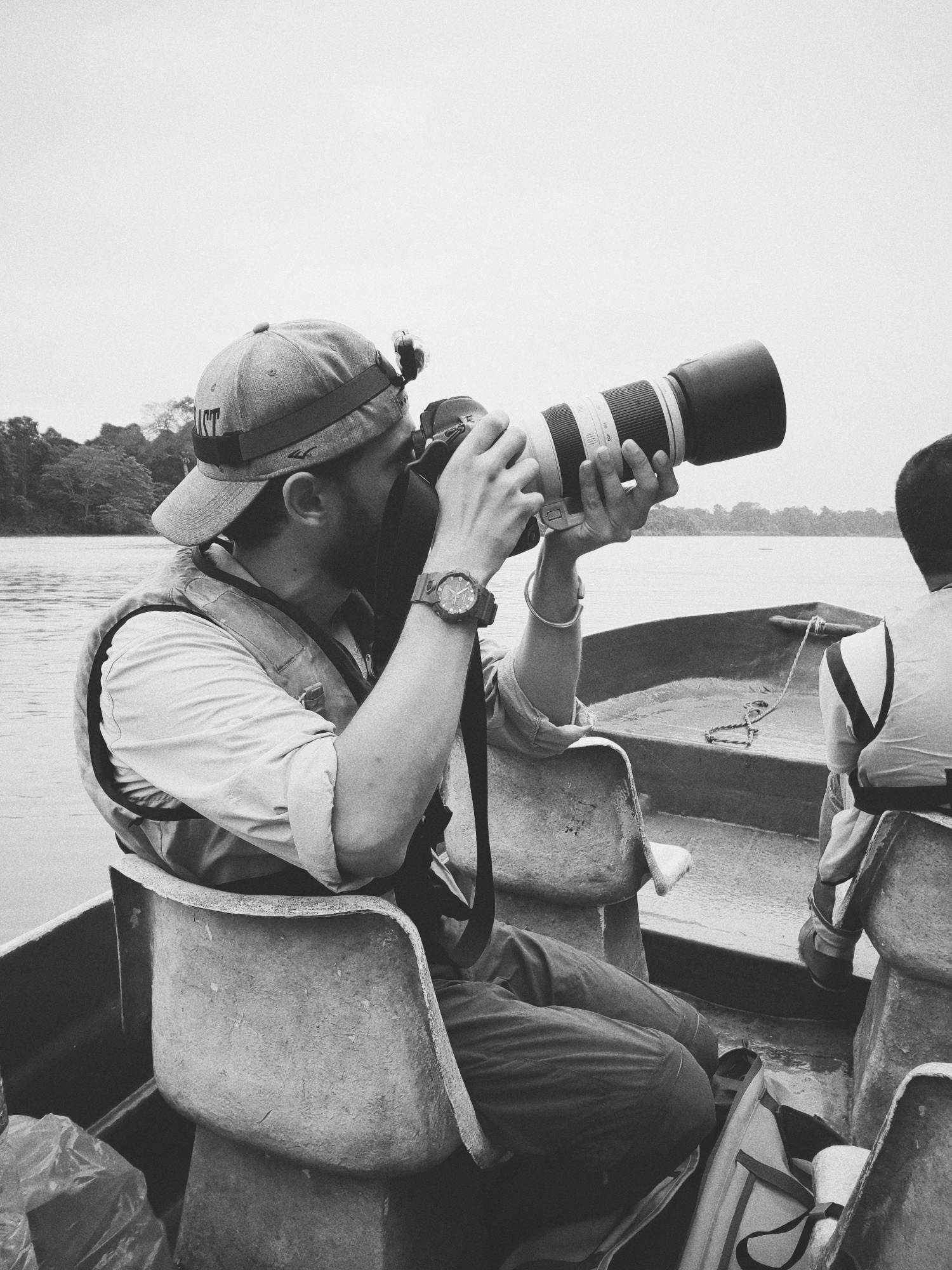 man on a boat holding a camera