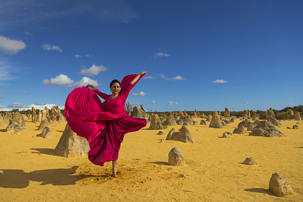 Ballet dancer in flowing pink dress pirouetting in the Pinnacles Desert, photographed with the Nikon 24-70mm f2.8 VR lens