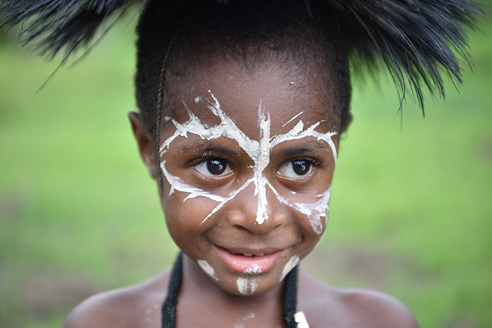 Close-up of child in traditional tribal headdress and face paint, photographed with the Nikon 24- 70mm f2.8 VR lens