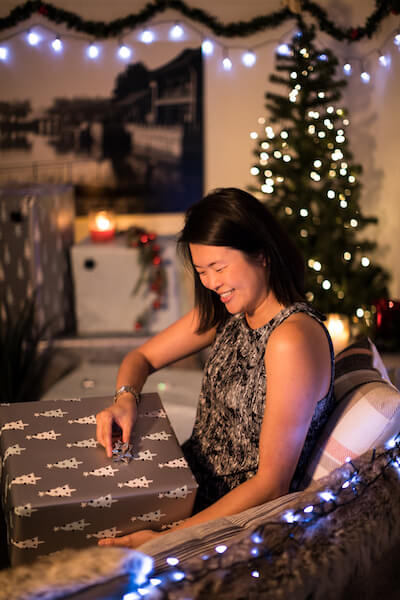 woman opening a gift in christmas day