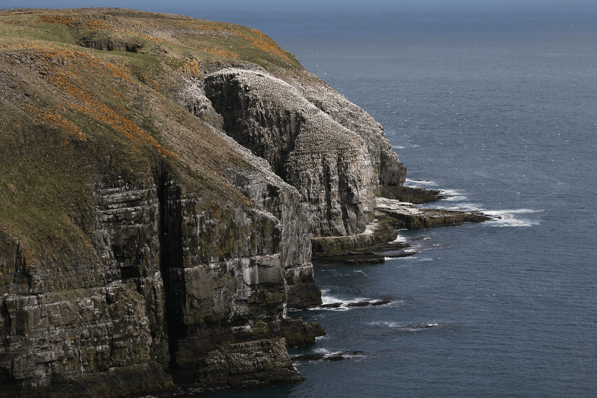 Grass-topped rocky cliffs jutting out to sea, photographed with the Canon EF 24-105mm f/4L IS II USM lens