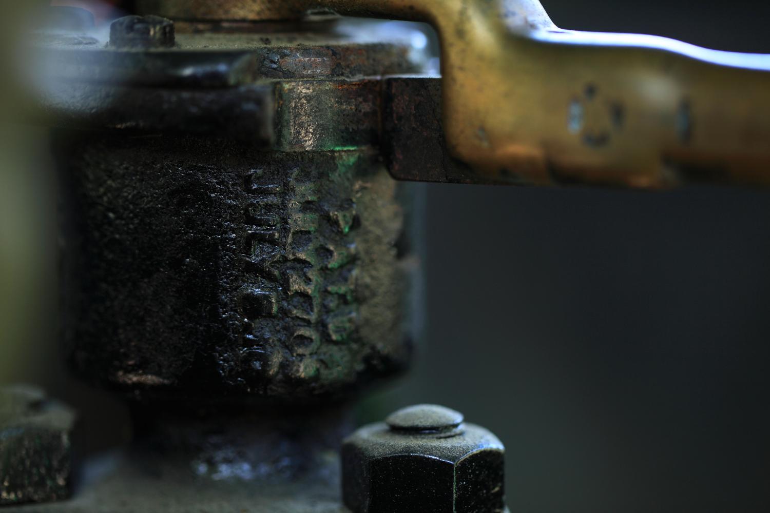 Close-up of writing on old metal mechanical part, photographed with the Canon 100mm Macro IS USM lens