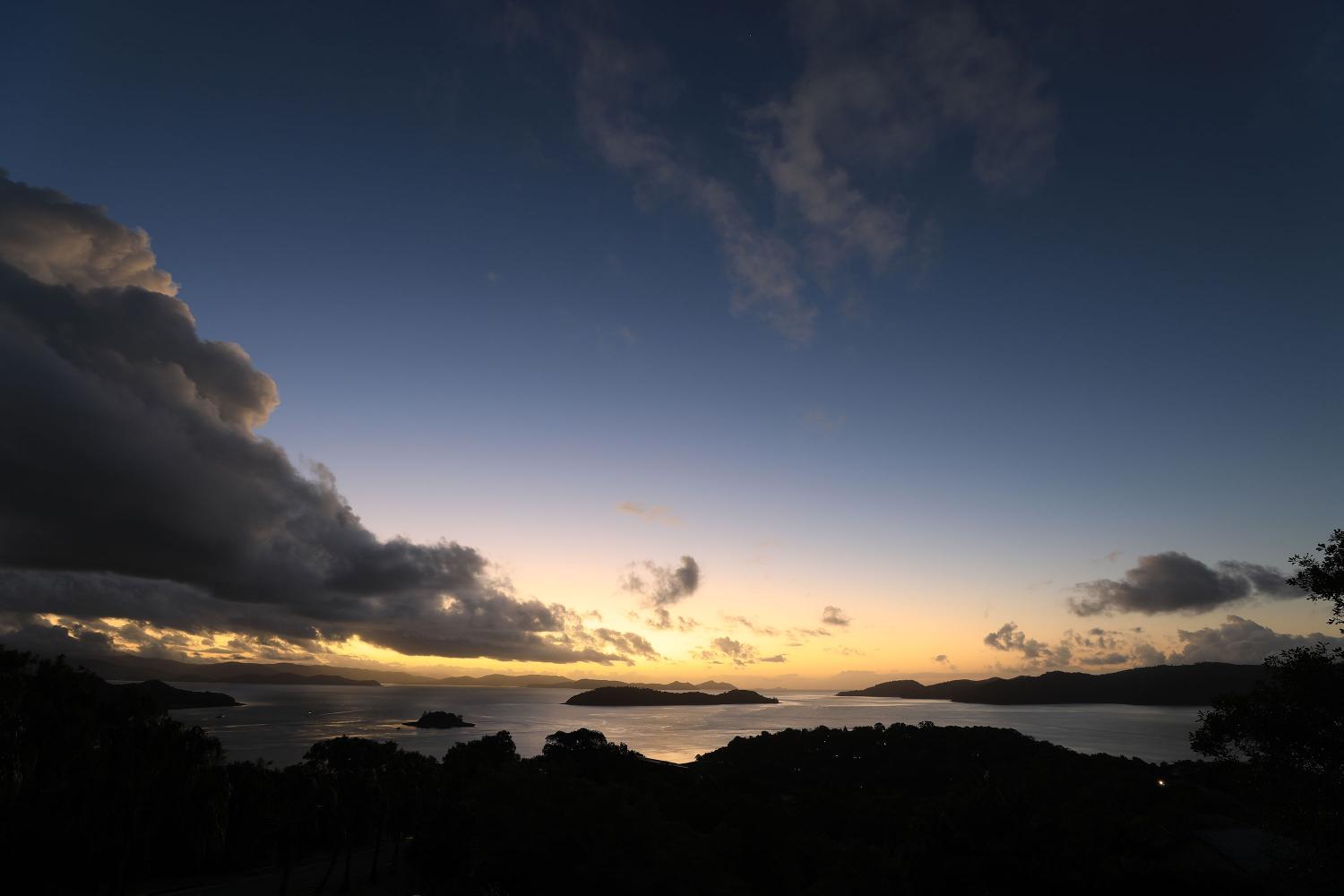 Sun setting behind islands and mountains in the distance, photographed with the Canon EF 16-35mm f/2.8L III USM Lens