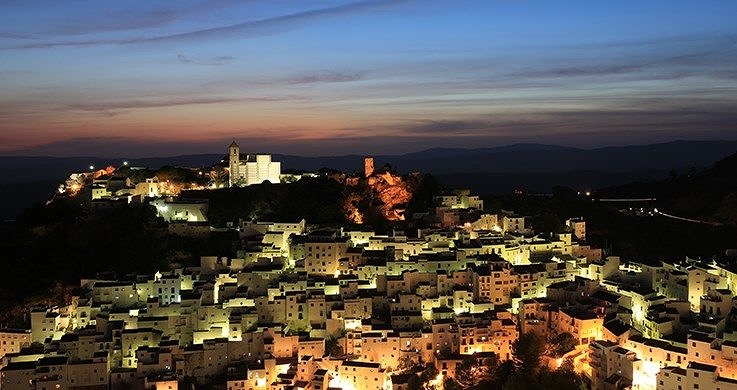 Mediterranean city buildings lit up beneath a darkening sky, photographed with the Canon 16-35mm f4 lens