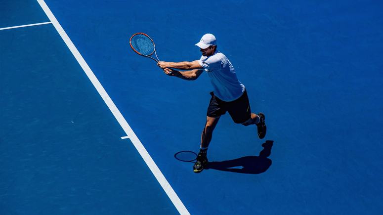 male tennis player on blue tennis court