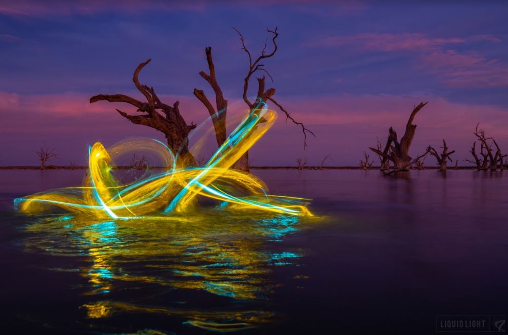 light painting photography with yellow and blue light streak