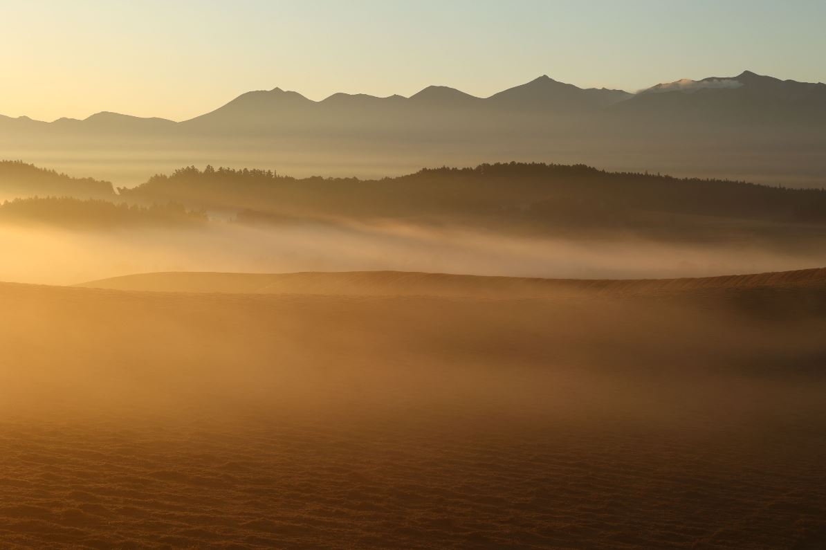 Golden mist floating across a silhouetted landscape, photographed with the Canon RF 70-200mm f4 L IS USM lens