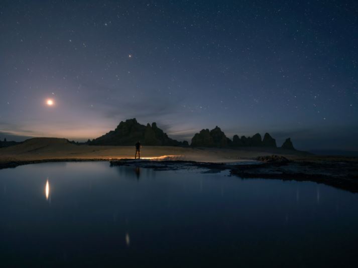 Figure standing on the far edge of a lake under a starry sky, photographed with the Fujifilm GF 30mm f3.5 R WR lens