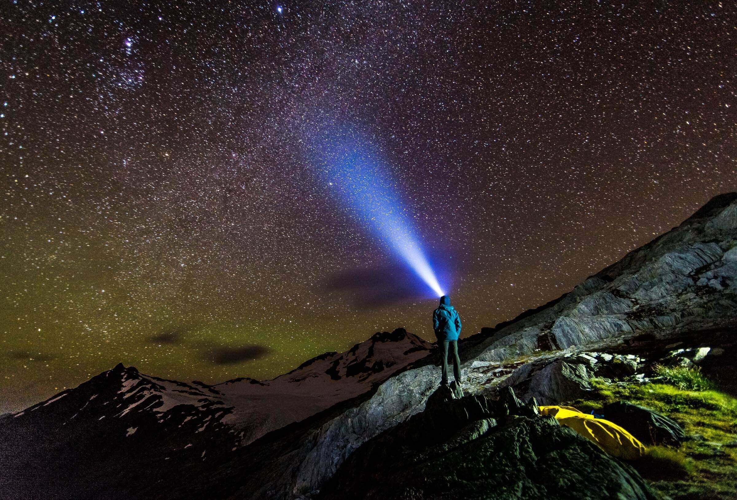 Self portrait looking up towards Mount Brewster in the New Zealand Southern Alps. Thegreen glow in the sky is a faint Aurora Australia.