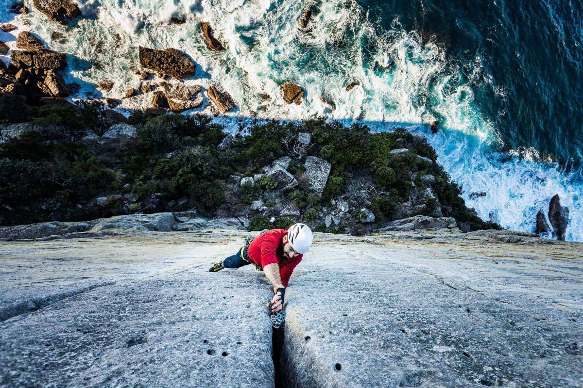 Alessandro Zen rock climbing at the steep sea cliffs of Point Perpendicular in NSW