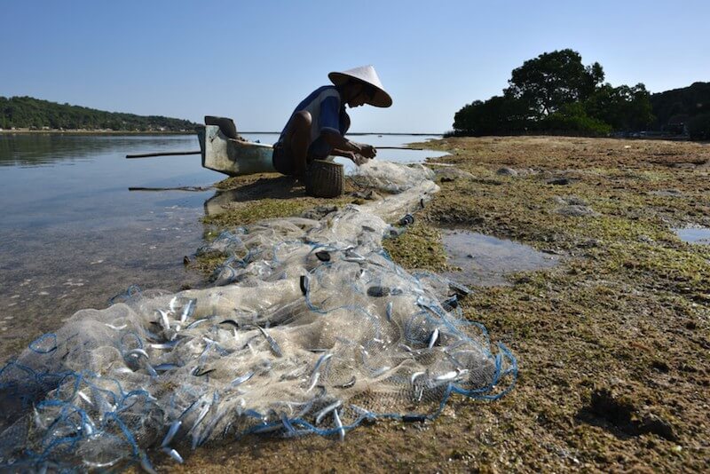 Fisherman fixing his net, taken using the Nikon 24mm f/1.8 lens