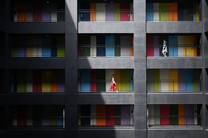 Apartment with people walking on each floor, taken with the Nikon 50mm 1.8 S lens