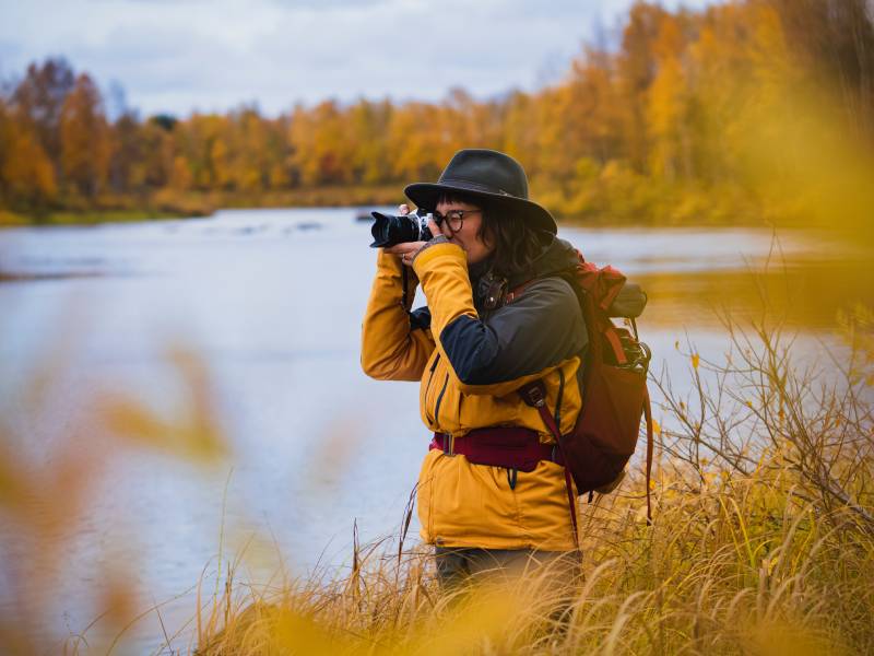 A guy taking photos by the lake, taken using the OM System M.Zuiko Digital ED 20mm F1.4 PRO Lens