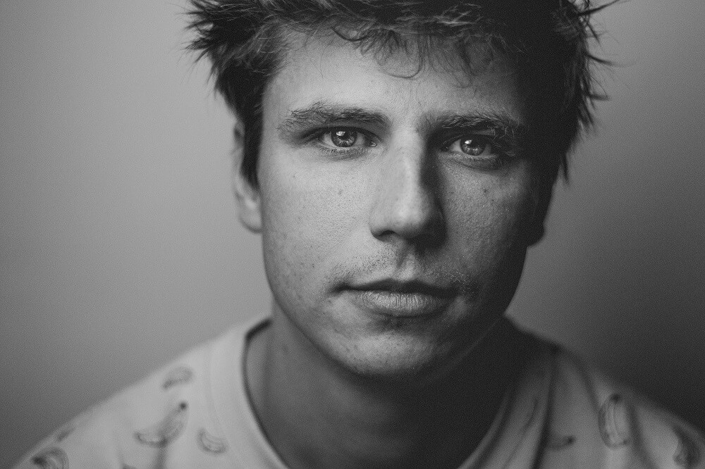 Close up portrait of a man in banana printed shirt, example of loop lighting setup