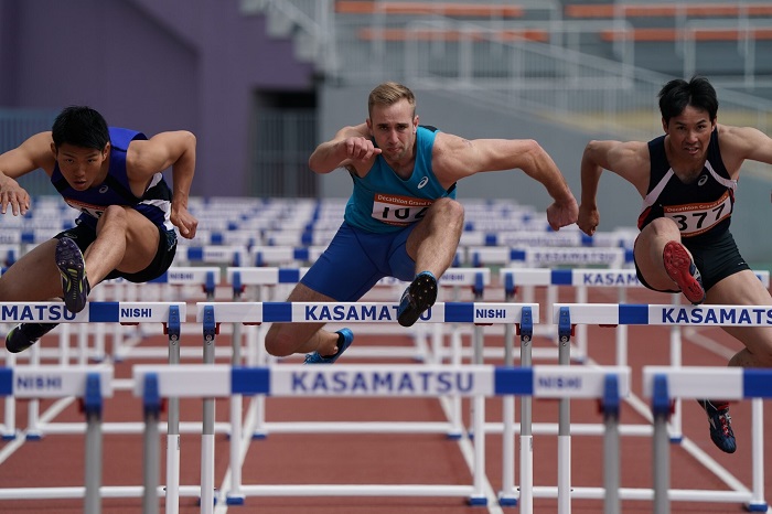 Front view of three male hurdlers jumping over hurdles, photographed with the Sony 200-600mm f5.6-6.3 G OSS lens