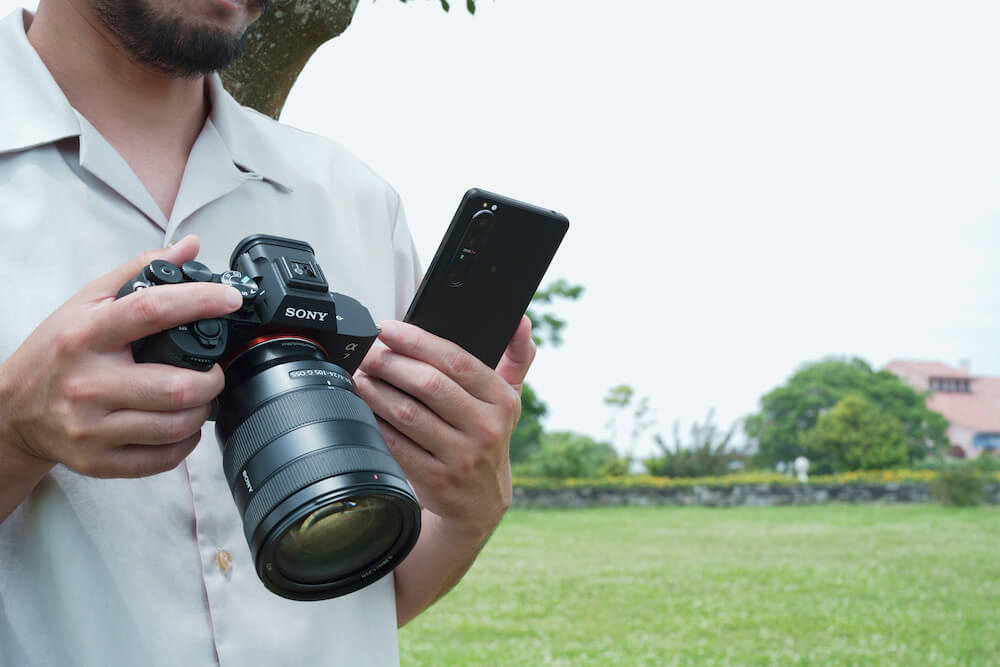 A guy transfering data from the Sony a7 IV to his phone