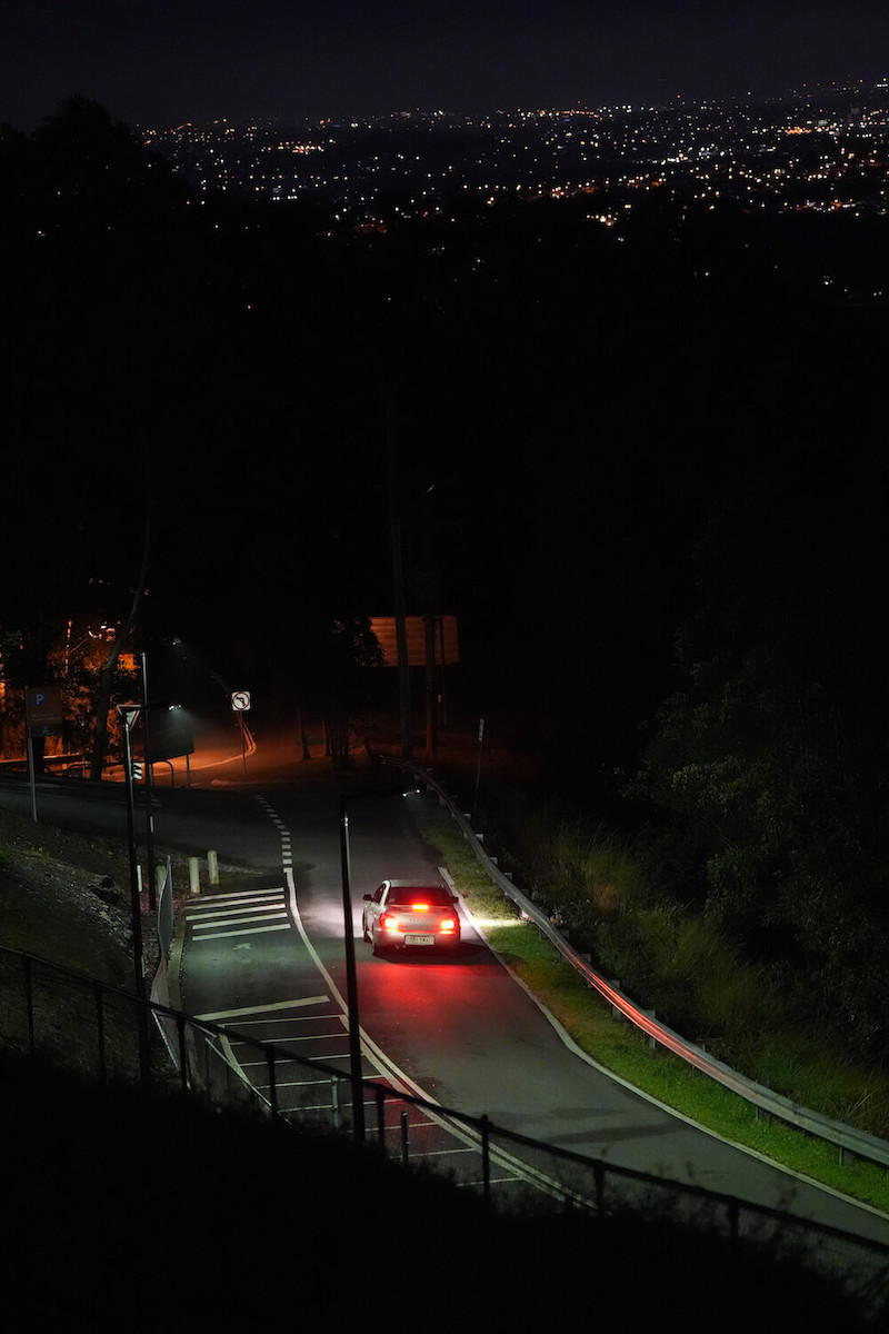 A car driving down the road at night, photo taken using the Sony a7 IV