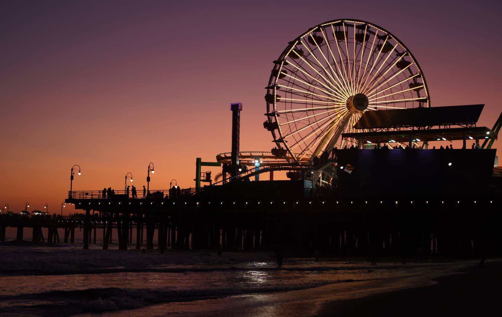 Seaside fairground lit up after sunset, photographed with the Sony FE 35mm f/1.8 lens