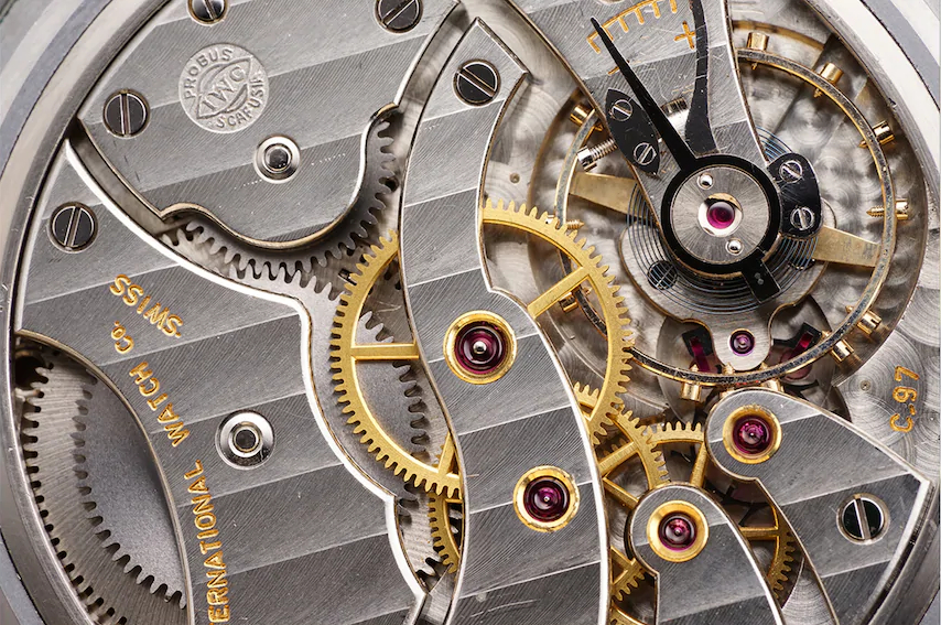 Close-up of the silver and gold interior parts of a Swiss watch, photographed with the Sony 90mm macro lens