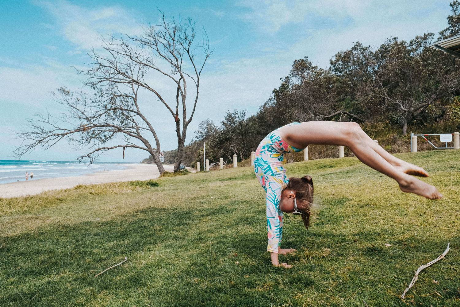 a girl doing acrobatic stunt while wearing glasses