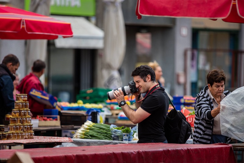 man taking street photography with his canon dslr