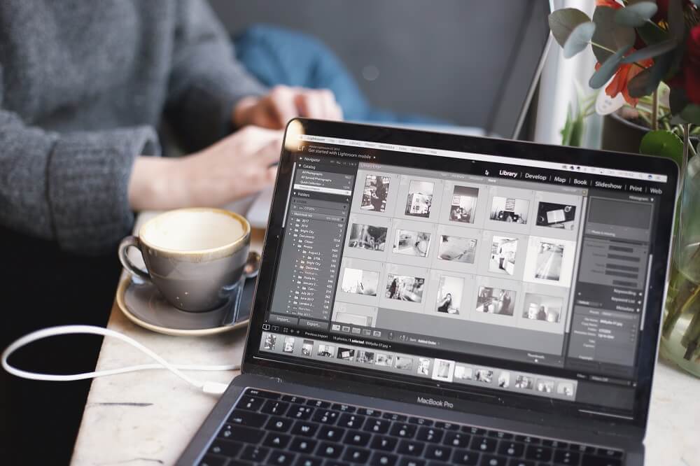 a person editing pictures on his laptop