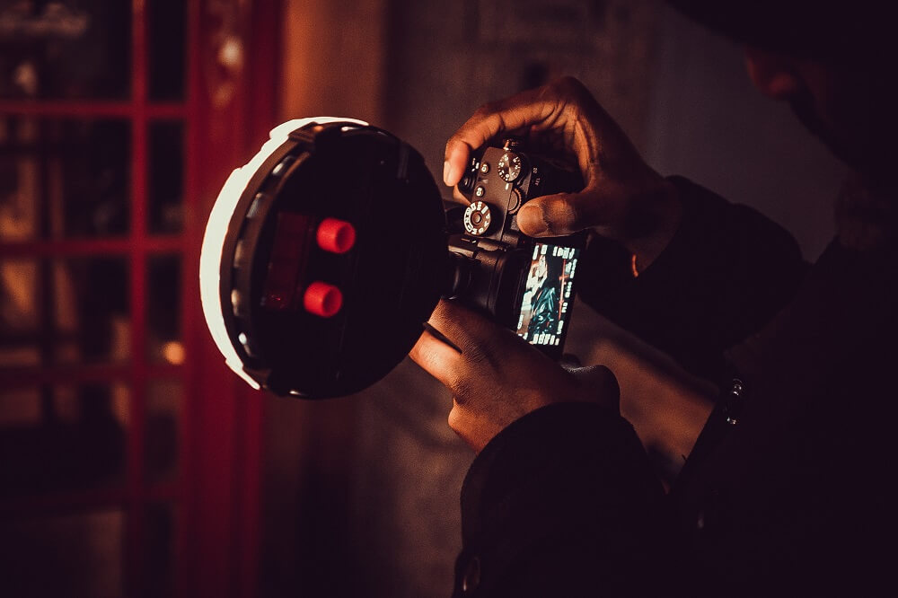 A photographer using a camera with flash