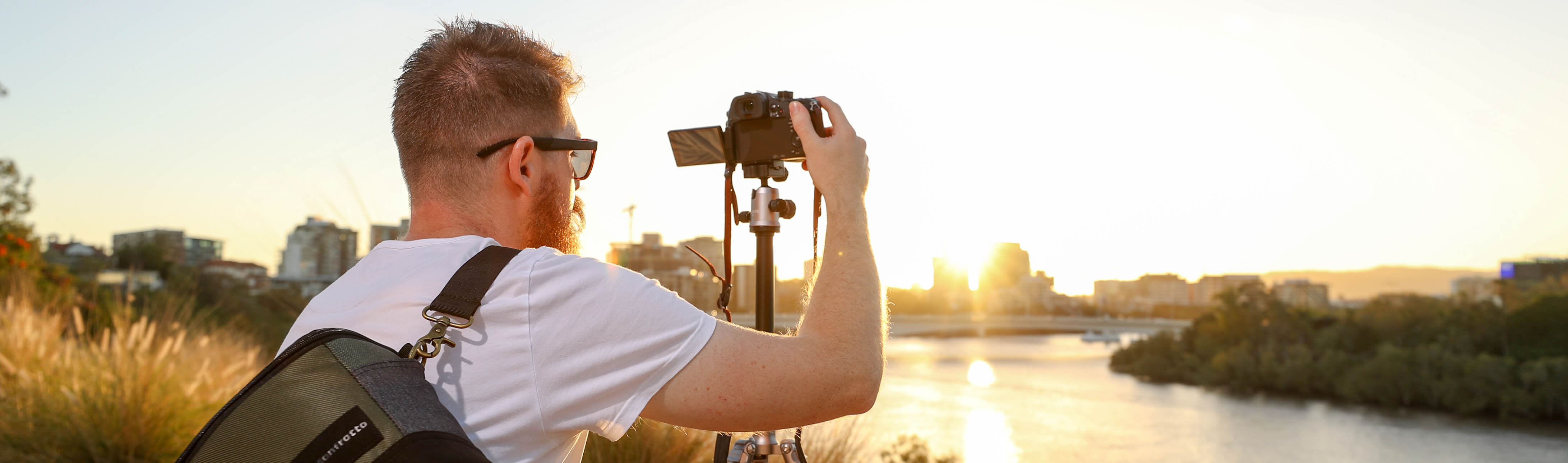 man using a mirrorless camera