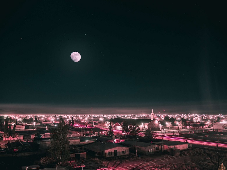 bright moon above a town