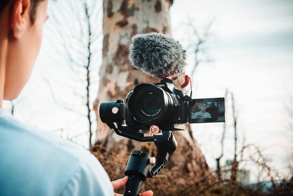 A guy holding a camera on a gimbal