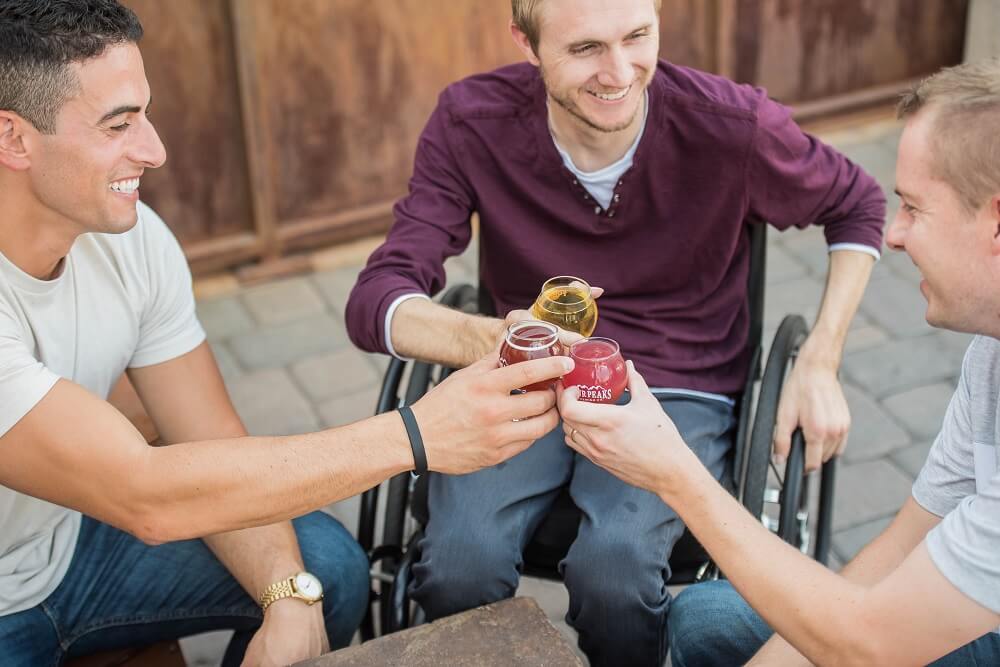 Three guys drinking during an event