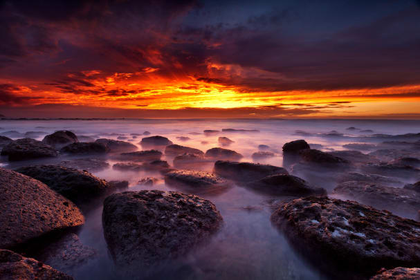 A rocky shore during sunset, taken using a LEE Filters Little Stopper