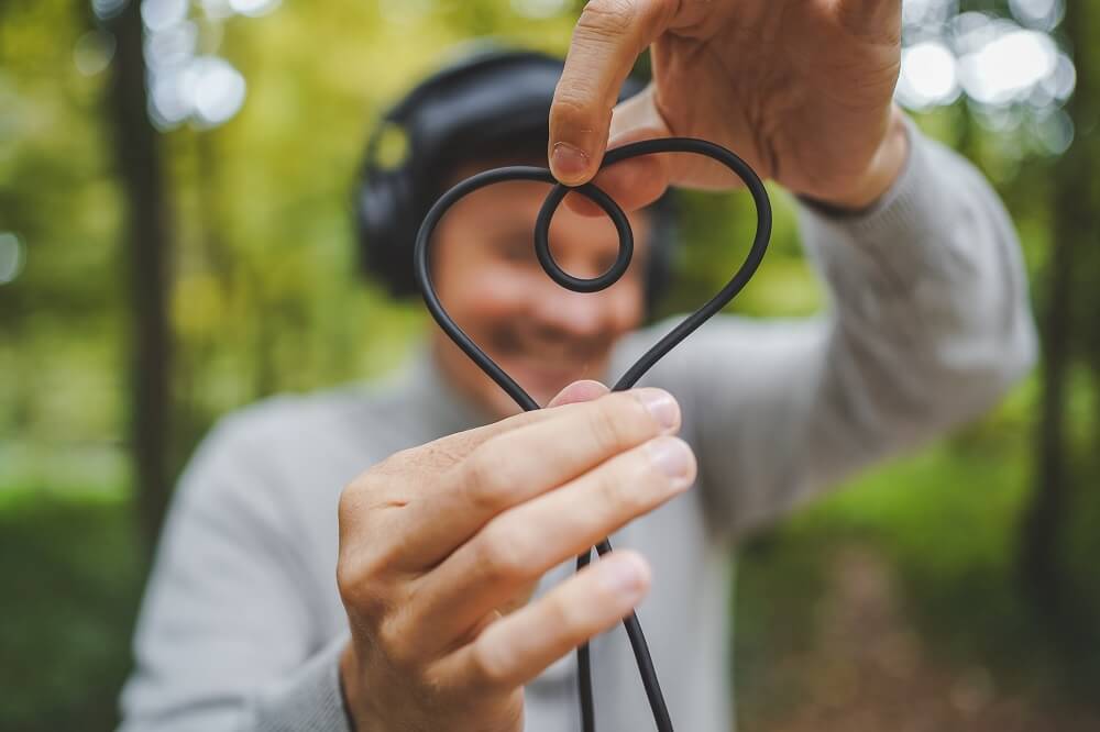 Man twisting a wire to form a heart