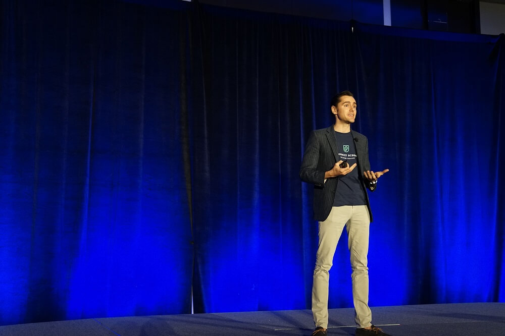 A guy speaking on stage during a school event