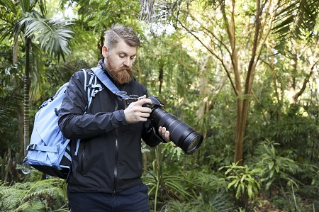 wild life photographer taking photos in the forest