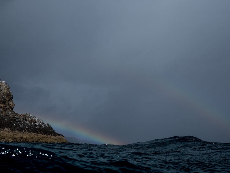 photo of a raindbow and the sea