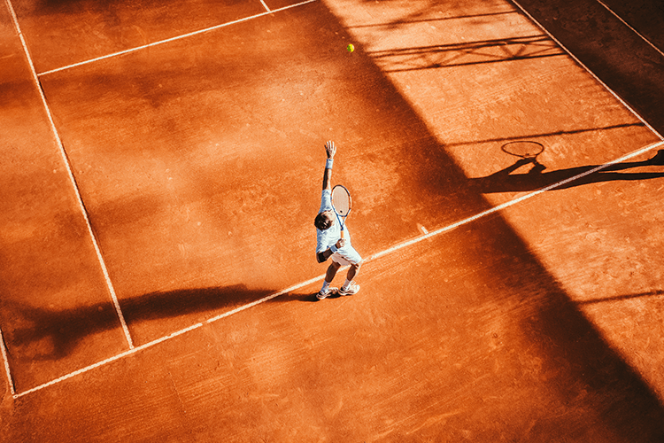 male tennis player hitting the ball