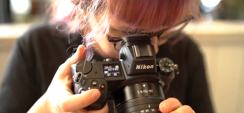 photographer trying the back button focus of a nikon camera