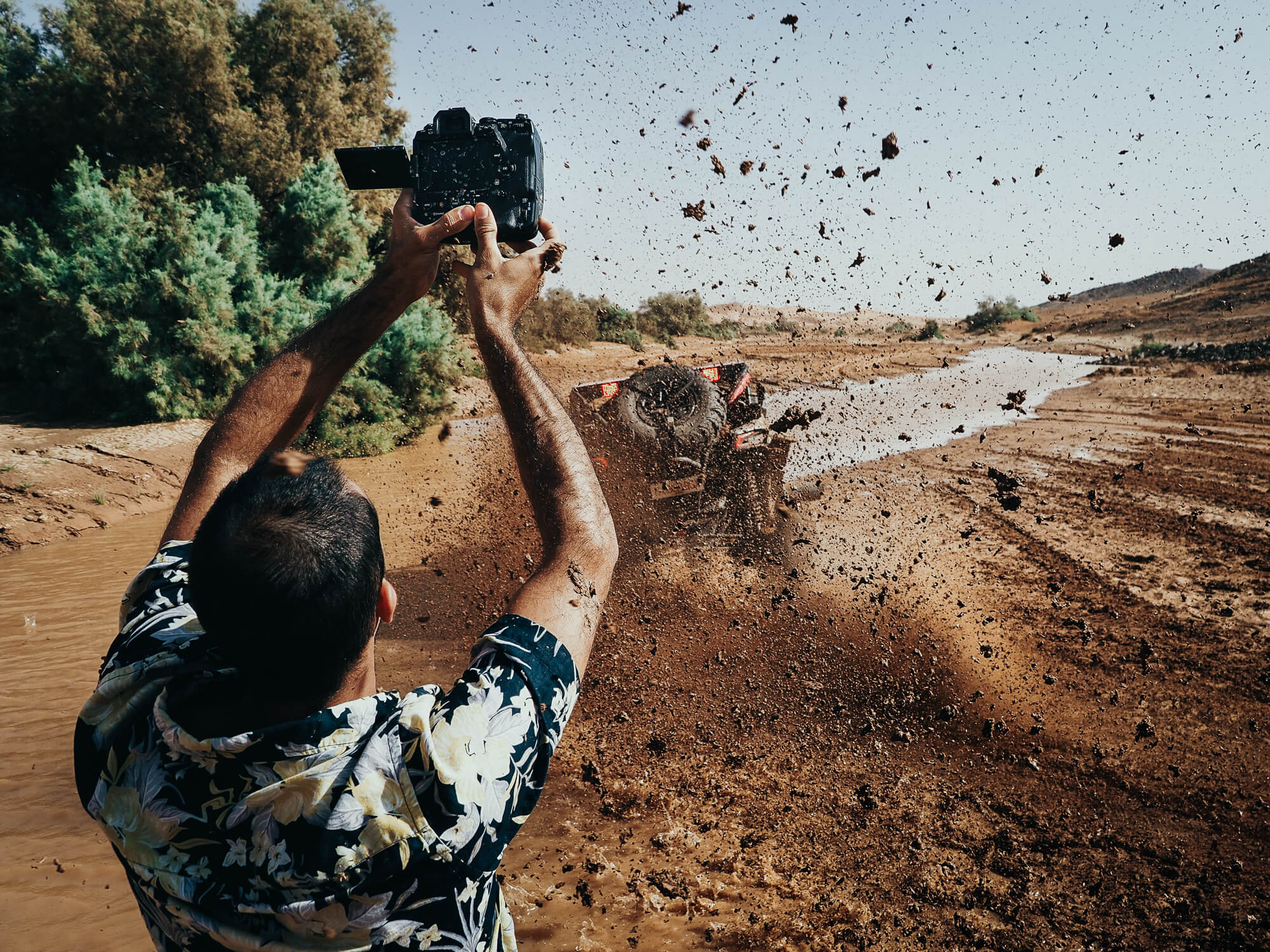 photographer taking photo of the muddy race track