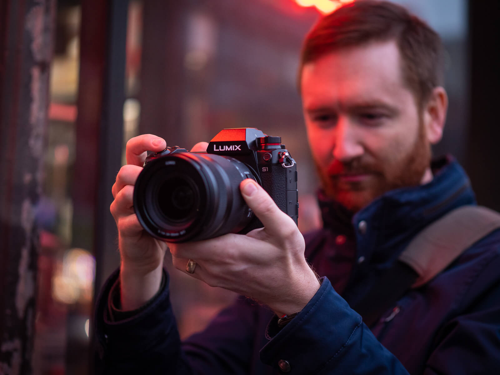 man holding the new lumix s1 camera