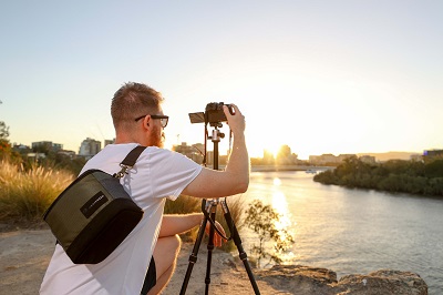 man with manfrotto bag using a camera attached to a convertible tripod