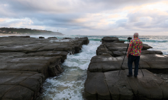 a man taking photo of the sea