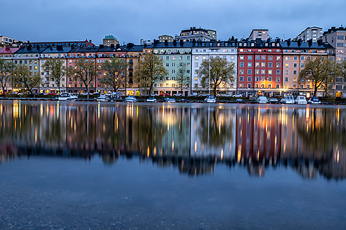 Colourful historic buildings mirrored in water, photographed with the Panasonic LUMIX S 20-60mm f3.5-5.6 lens 