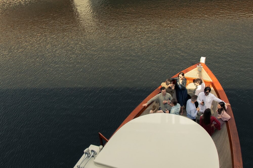 A group of people drinking during an event in a boat