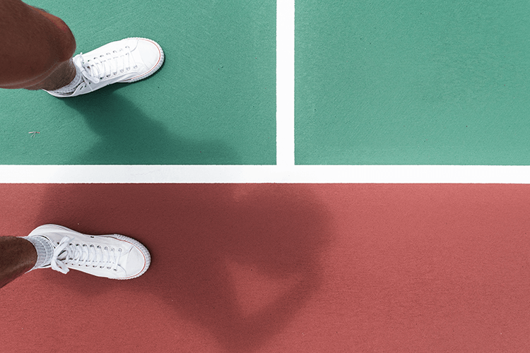 white shoes of a tennis player while on tennis court