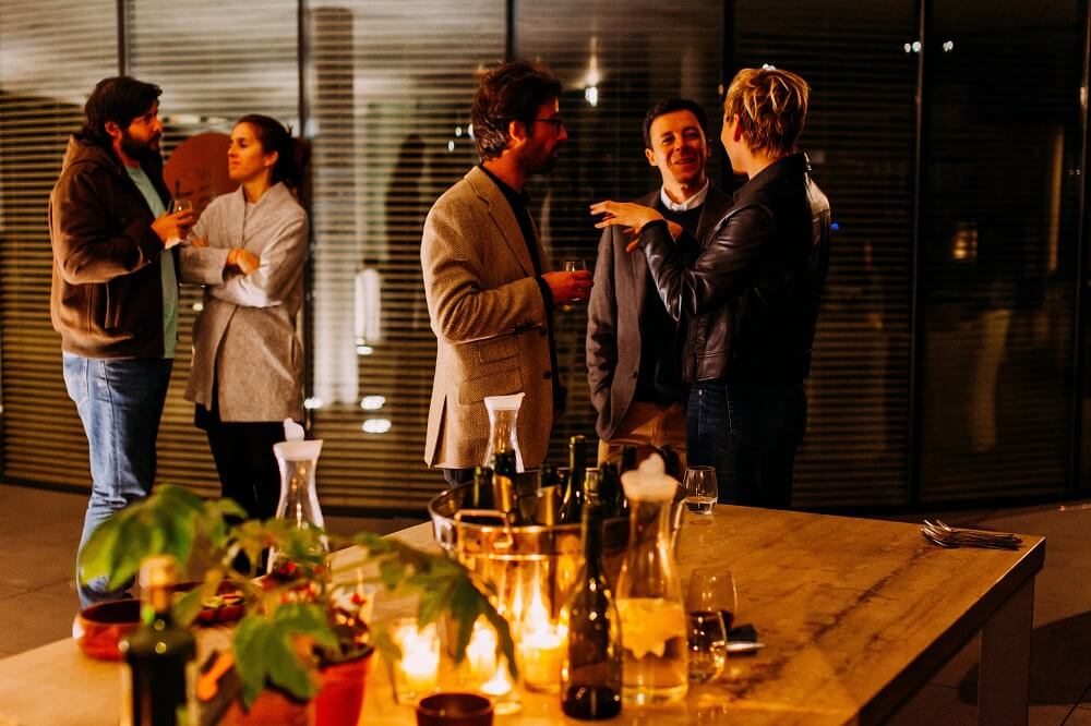 A group of people talking during an indoor event