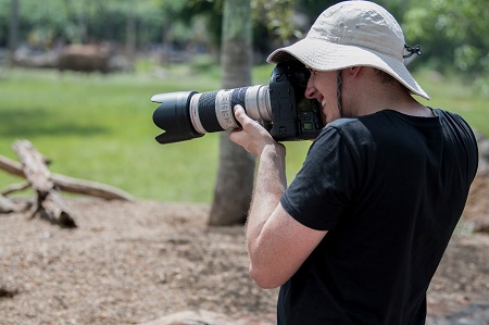 wildlife photographer taking photos in a zoo