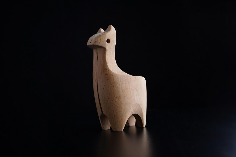 Photo showcasing the effect of side lighting on a wooden horse display